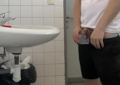 Guy Taking a Urine Sample in Hospital Toilets