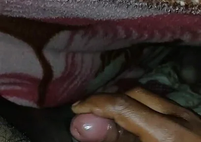 Big Boss massaging penis oil under the blanket