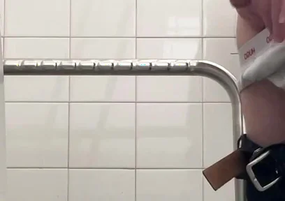 In the Hospital Toilets, a Guy Pisses Into a Cup for a Urine Sample, Then Gets Horny, Jerks-off and Cums