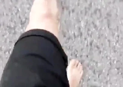 Jon Arteen Walks Barefoot on the Street Outdoors, the Boy Is Barefoot in the Crowded Tram to the Town Center