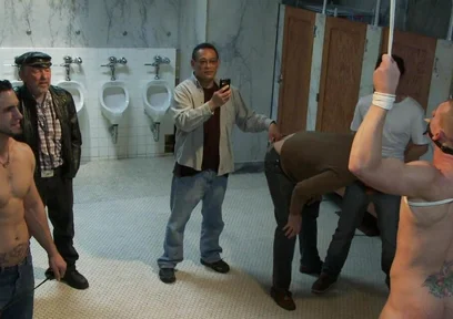 The Wrestler Gets Gang Banged by a Horny Crowd in a Public Restroom for Losing His Match.
